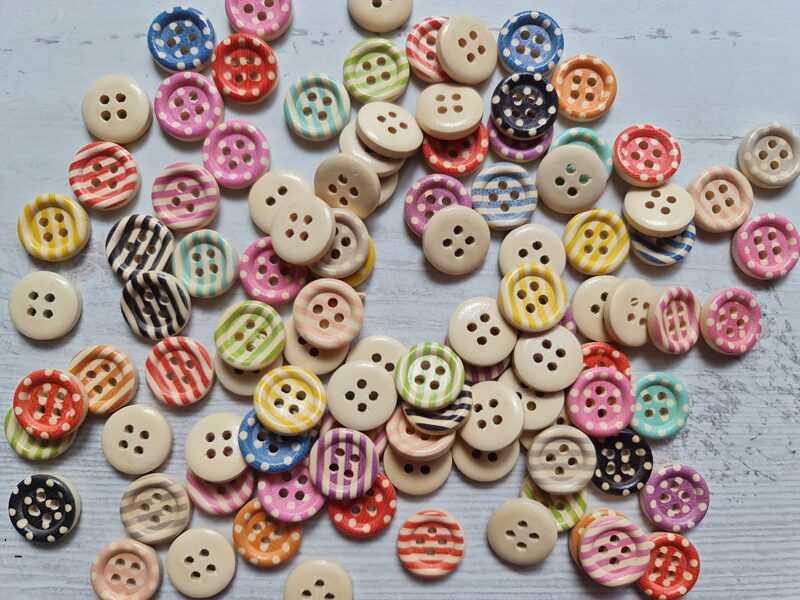 Wooden button with words - with stripes and dots on surface